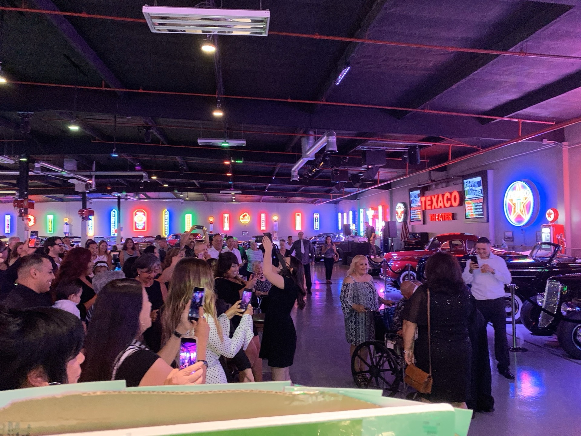 Milestone celebration with crowd and neon signs at Highway 39 Event Center in Anaheim