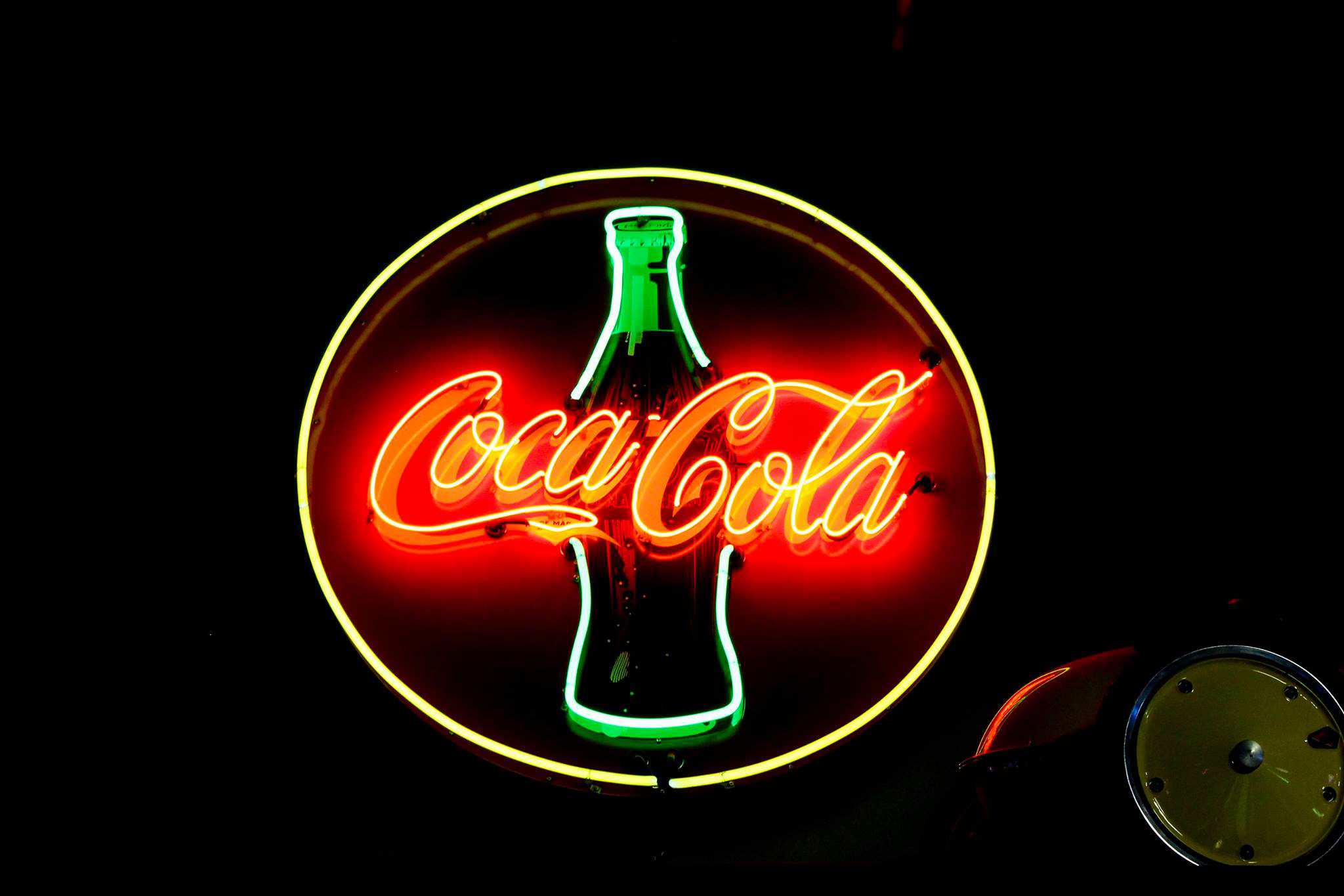 Neon Coca-Cola sign illuminated at Highway 39 Event Center in California.