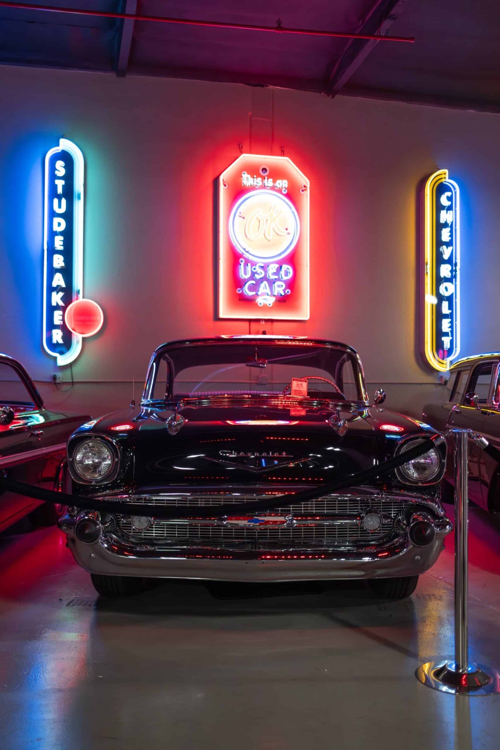Neon signs and vintage car showcase at Highway 39 Event Center, perfect for automotive enthusiasts a.