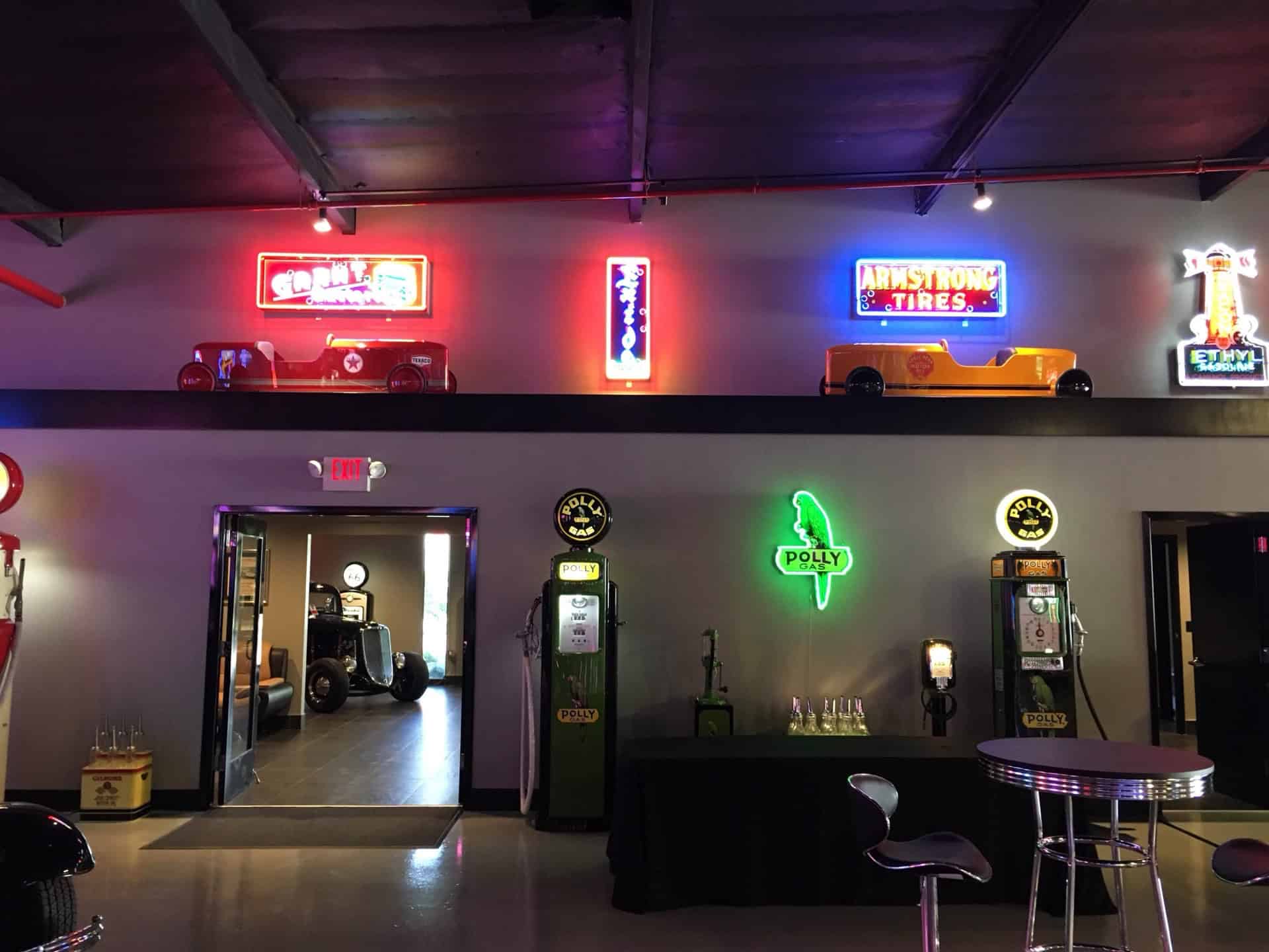 Neon signs and vintage cars decor at Highway 39 Event Center, creating a retro and vibrant atmospher.
