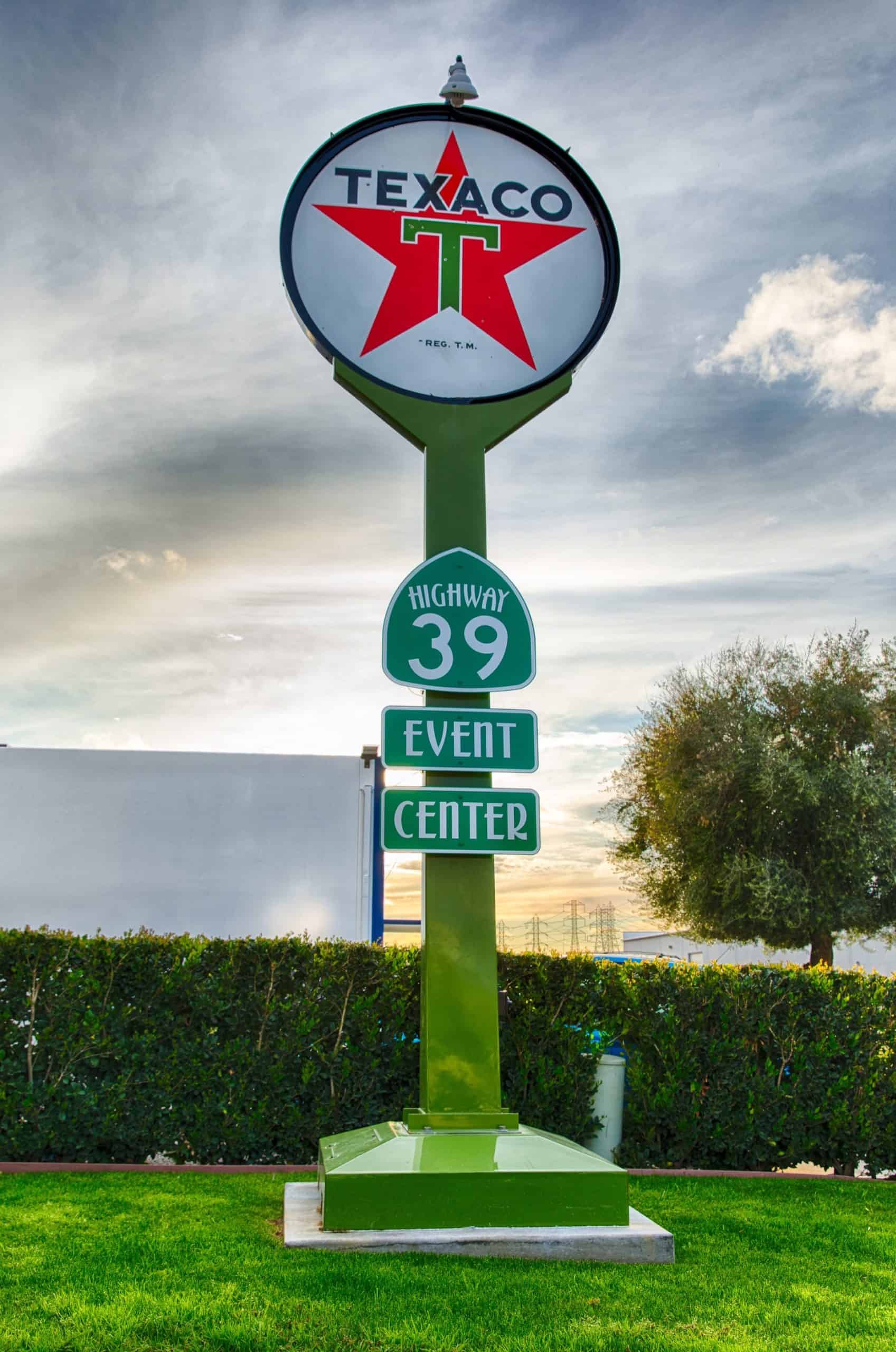 Highway 39 Event Center sign with Texaco logo and green directional sign.