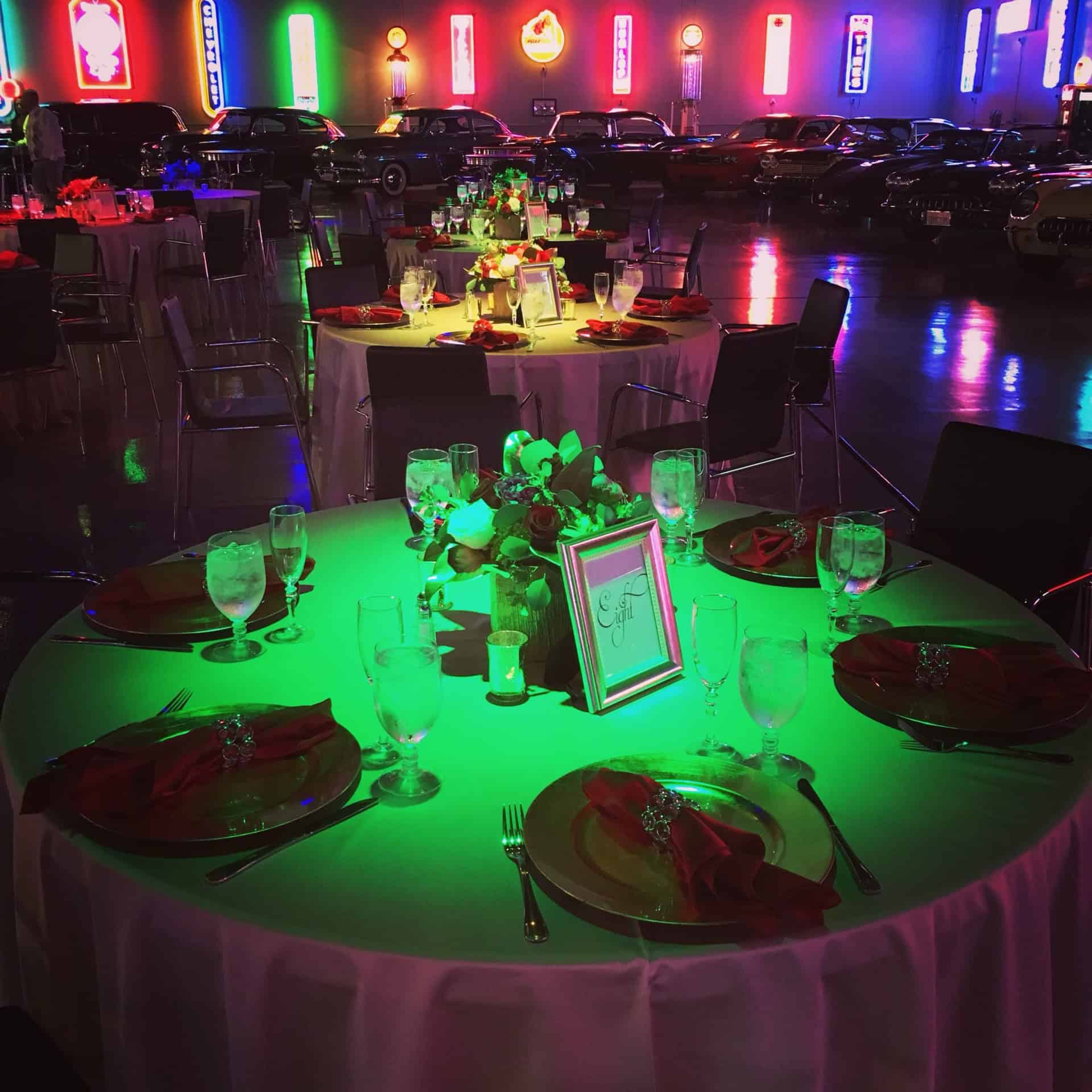 Lit event space with decorated tables and vibrant lighting at Highway 39 Event Center.